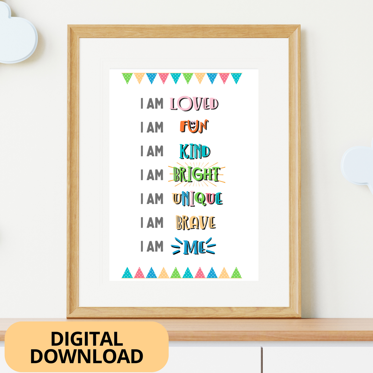 I AM Poster containing colourful self-affirmations for kids, framed in a light wooden frame on top of a chest-of-drawers.